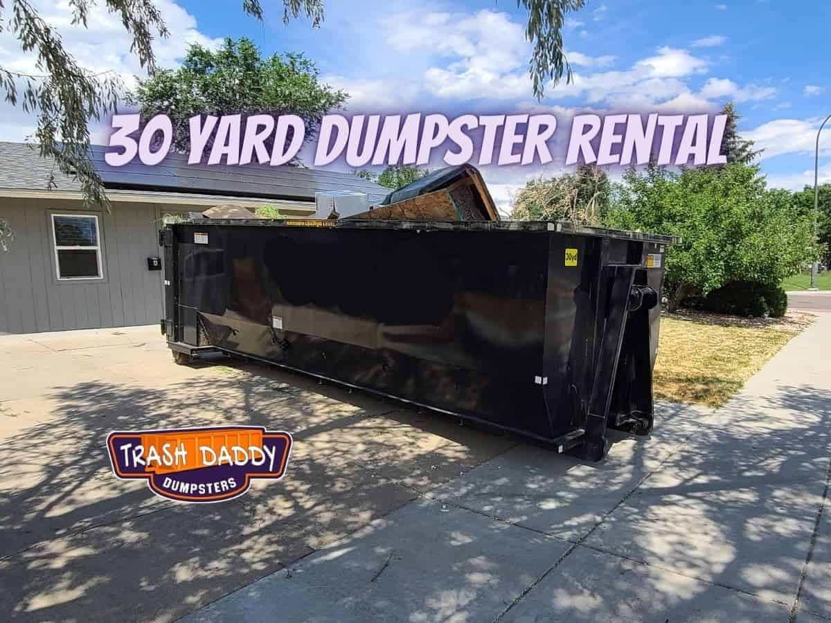 black 30 yard dumpster in driveway in parker