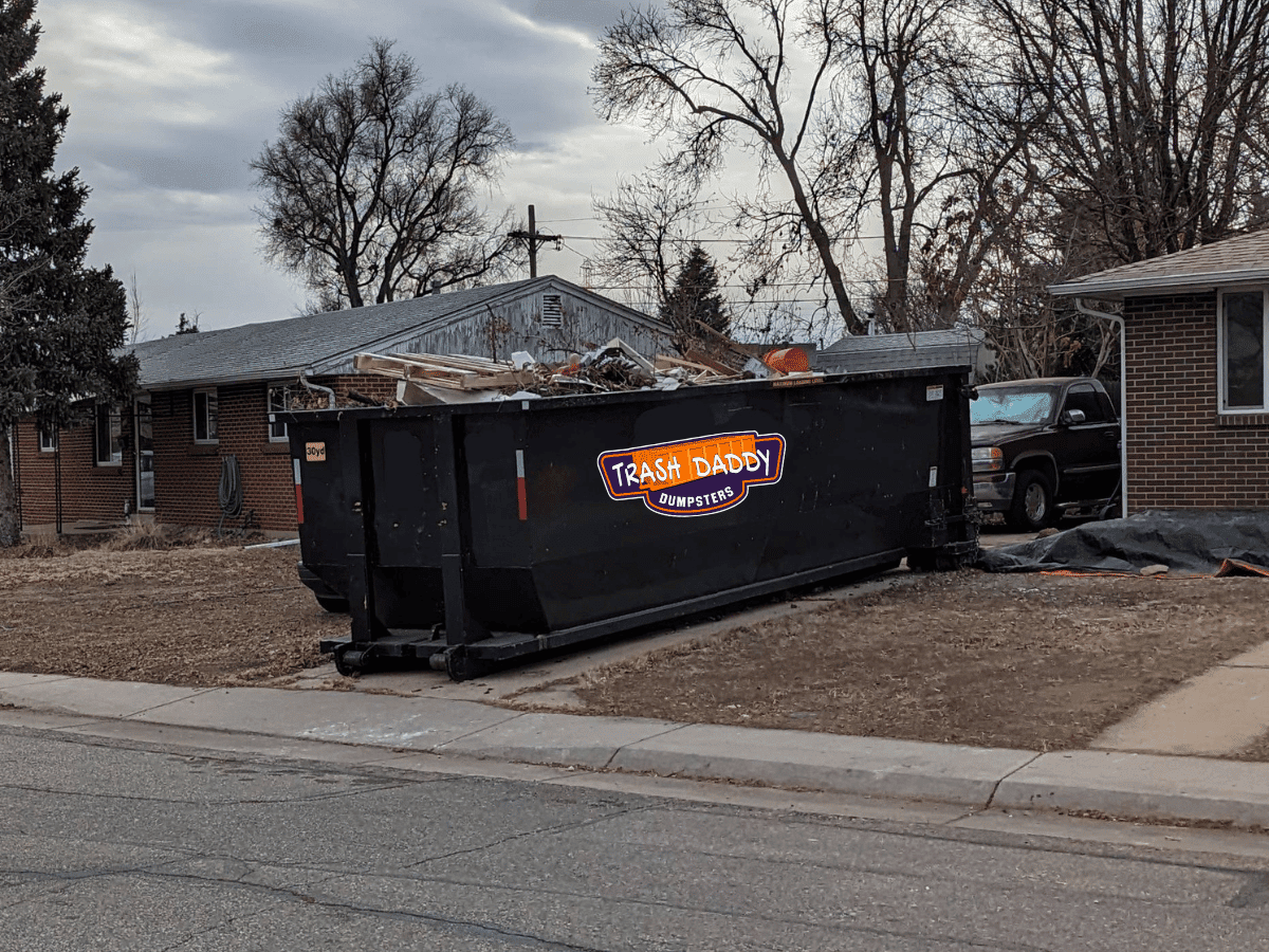black 30 yard dumpster in a driveway