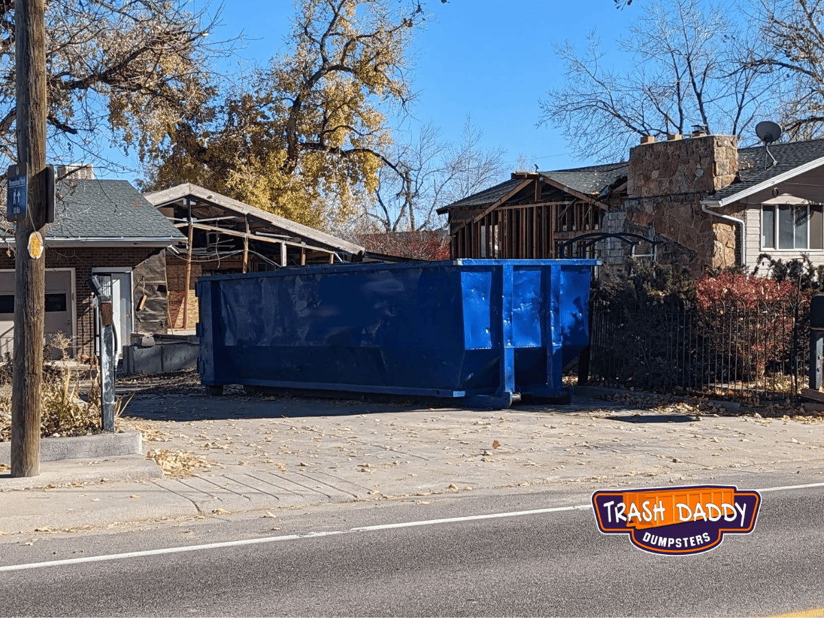 blue 30 yard dumpster in driveway