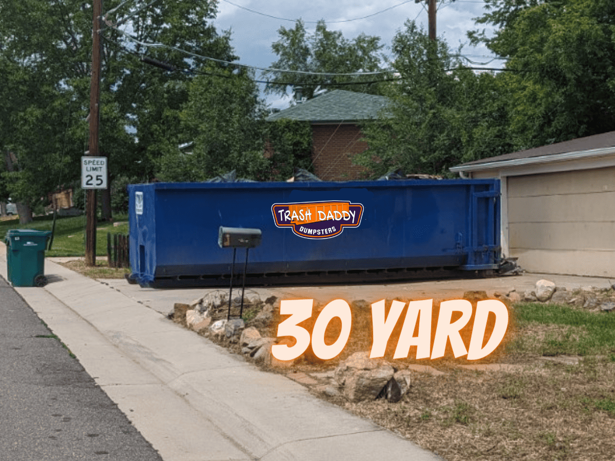 blue 30 yard dumpster in a driveway