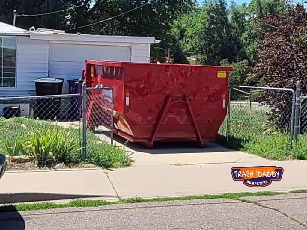 10 yard dumpster in a small driveway
