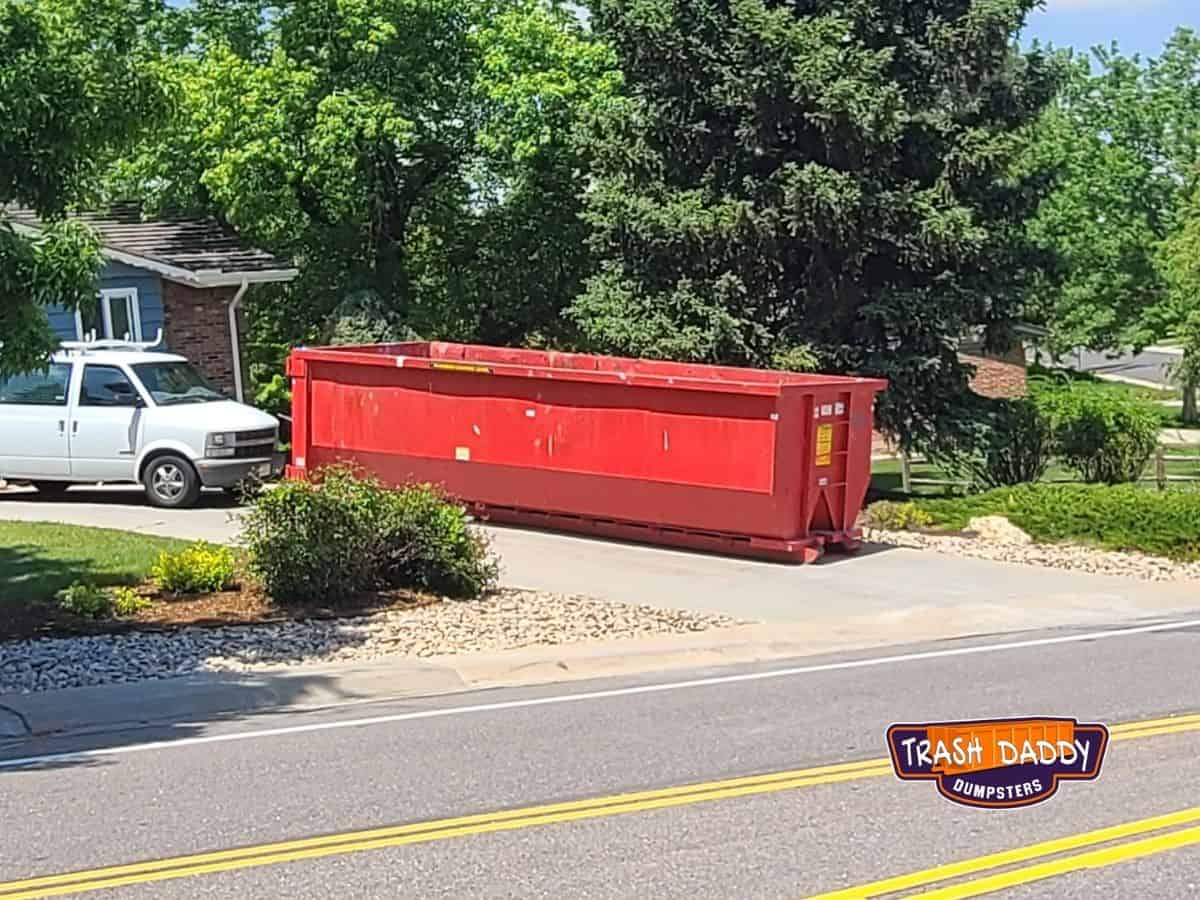 red 30 yard dumpster in a driveway