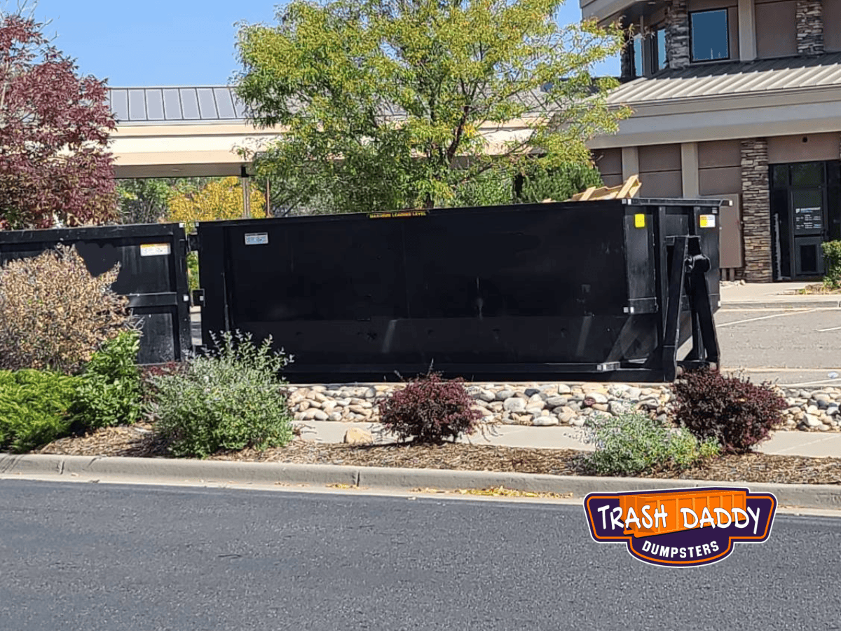 black 30 yard dumpster in parking lot