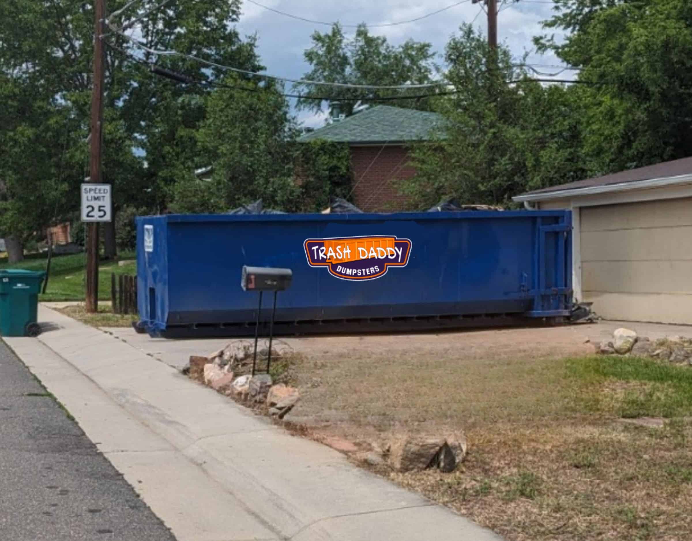 blue 30 yard roll-off dumpster in a driveway