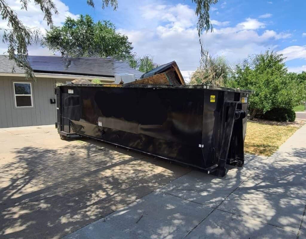 black 30 yard dumpster in driveway