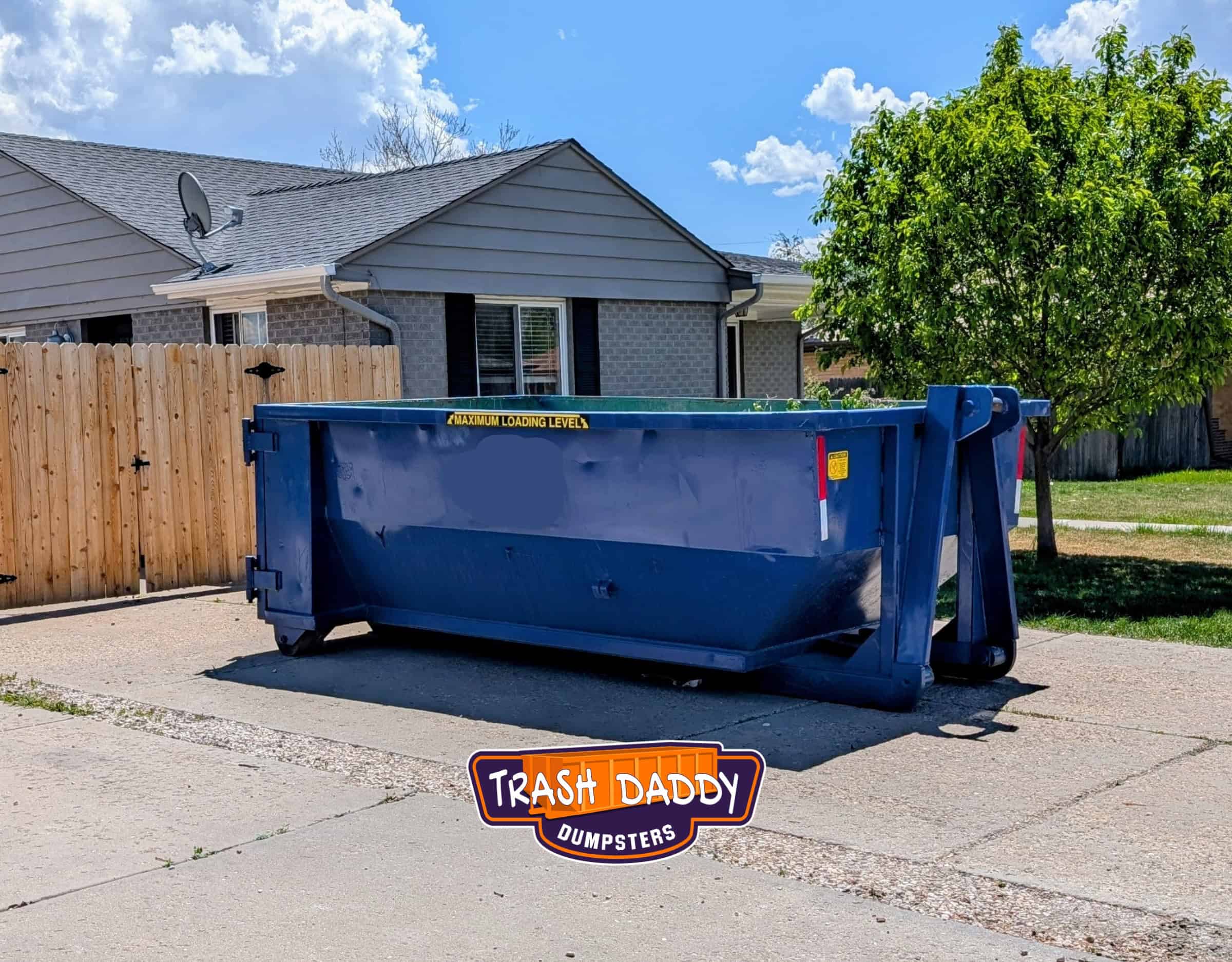blue 15 yard dumpster rental in a driveway