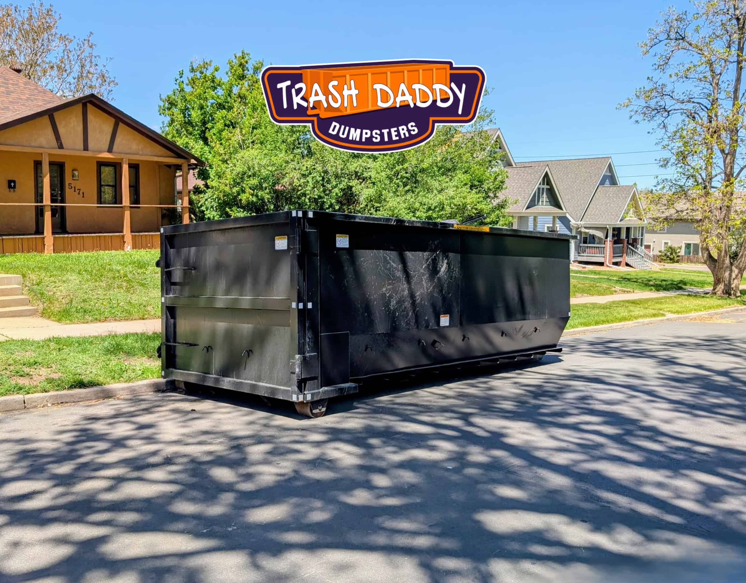 black 20 yard dumpster in the street
