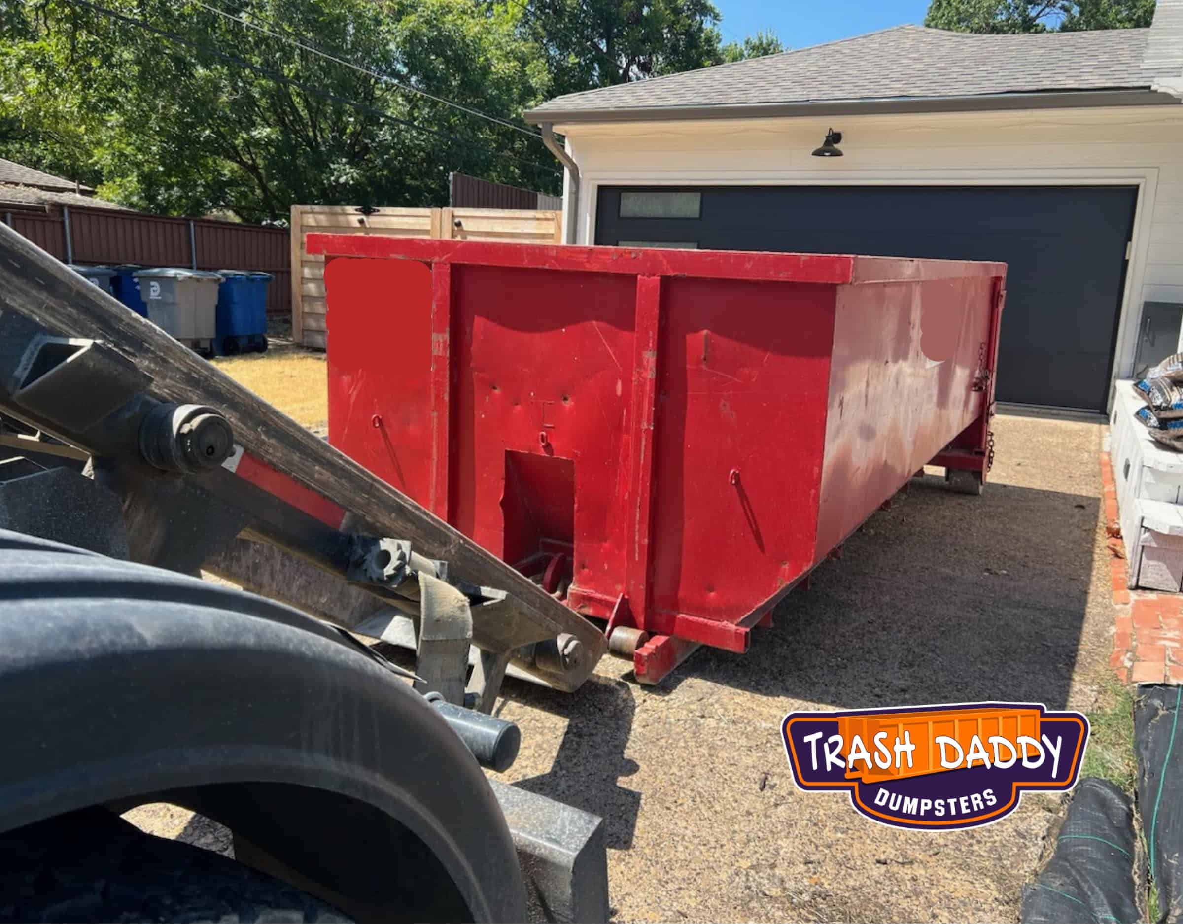 red 20 yard dumpster dropped in a driveway