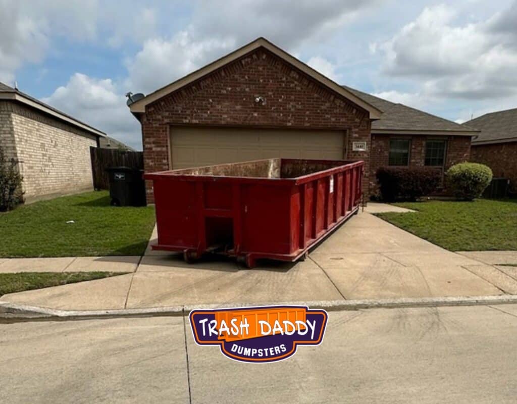 red 20 yard dumpster in a driveway