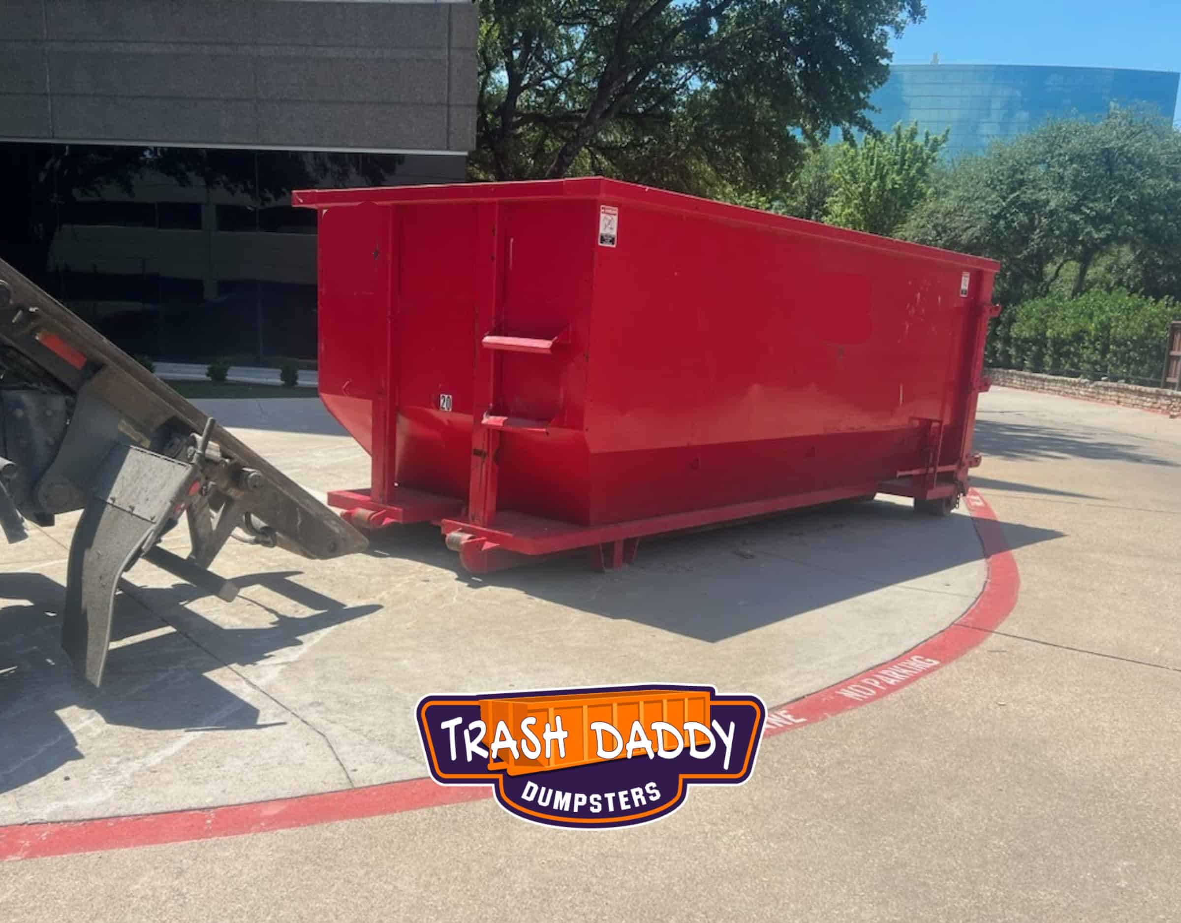red high side 20 yard dumpster in front of a commercial building