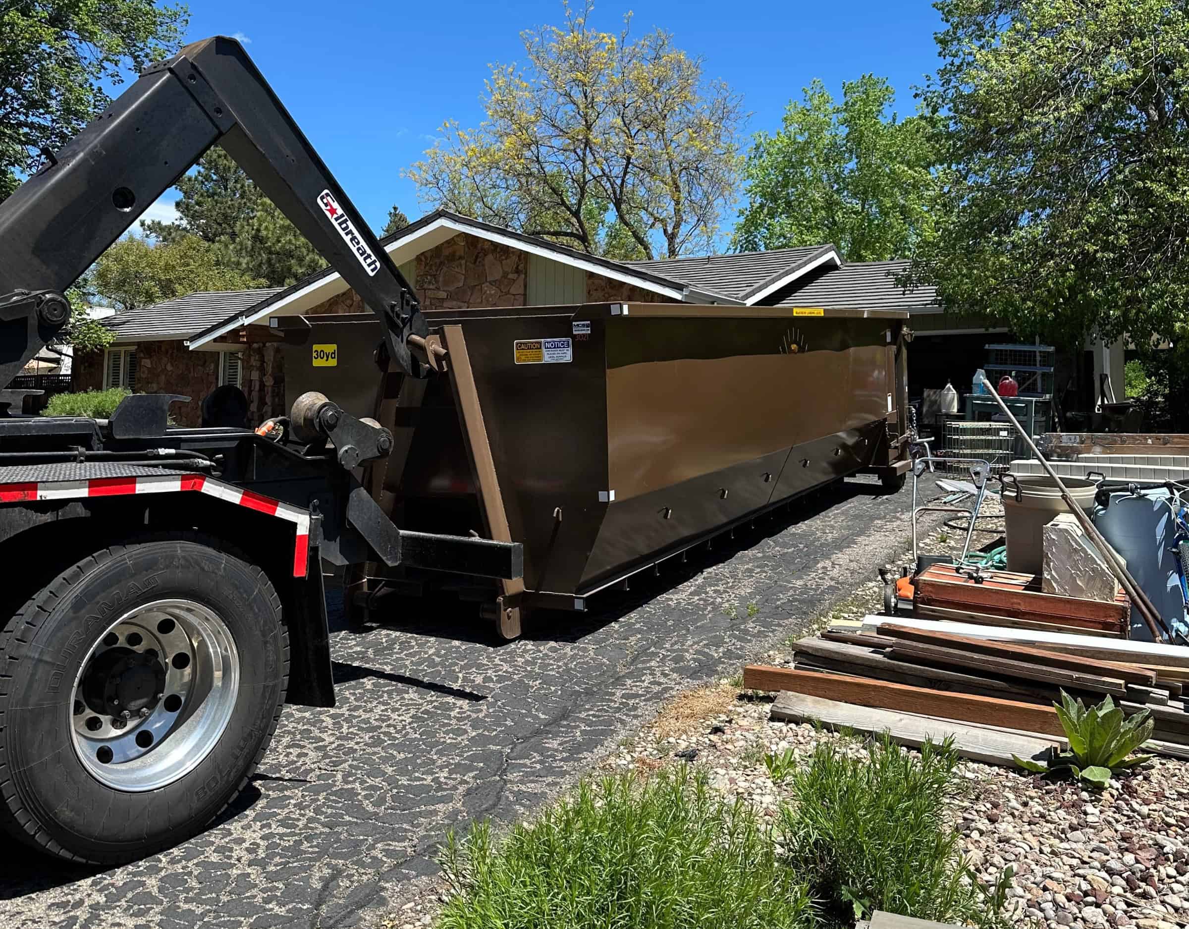 brown 30 yard dumpster dropped in a driveway