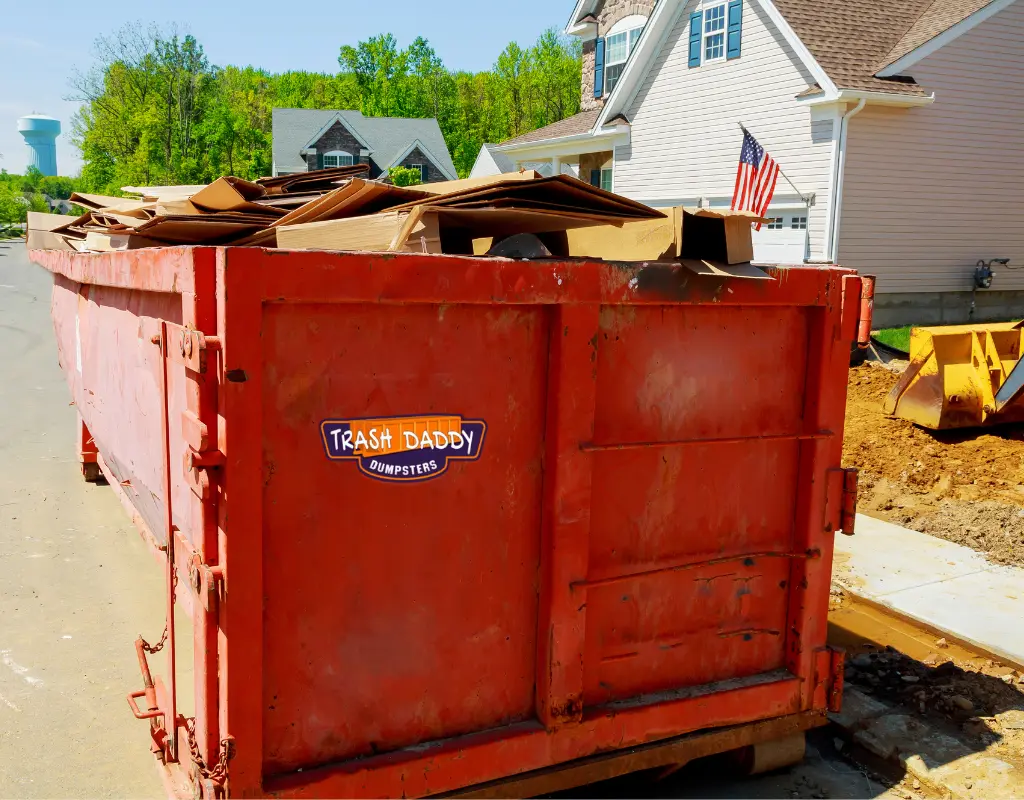 High side dumpster carrying cardboard