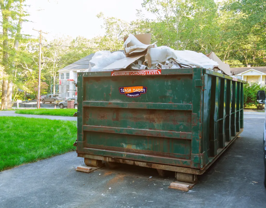 High side dumpster showing what types of trash it can take