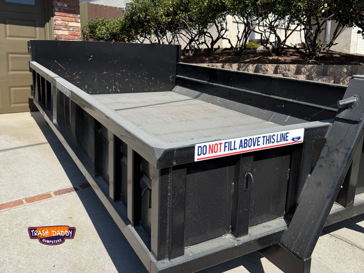 8 yard lowboy dumpster in a driveway