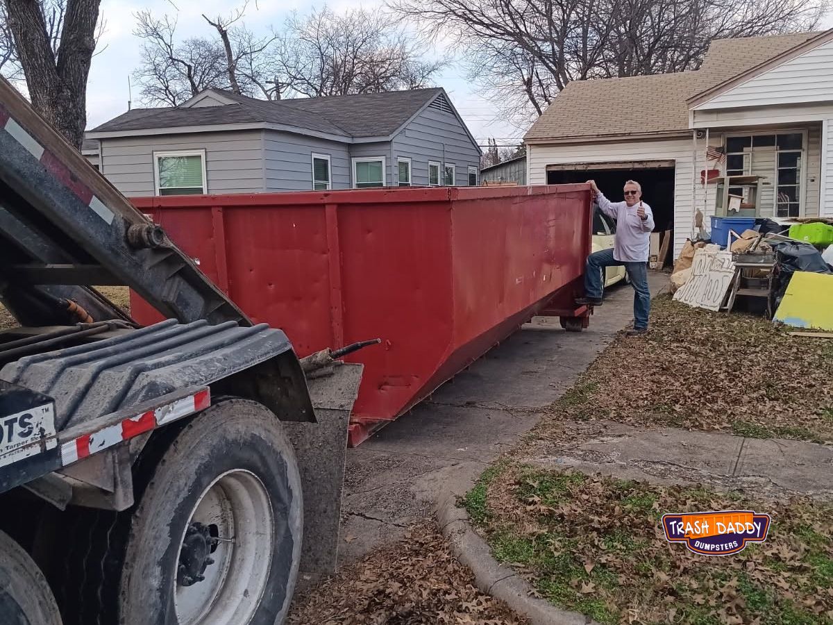Red 20 yard roll off in a driveway