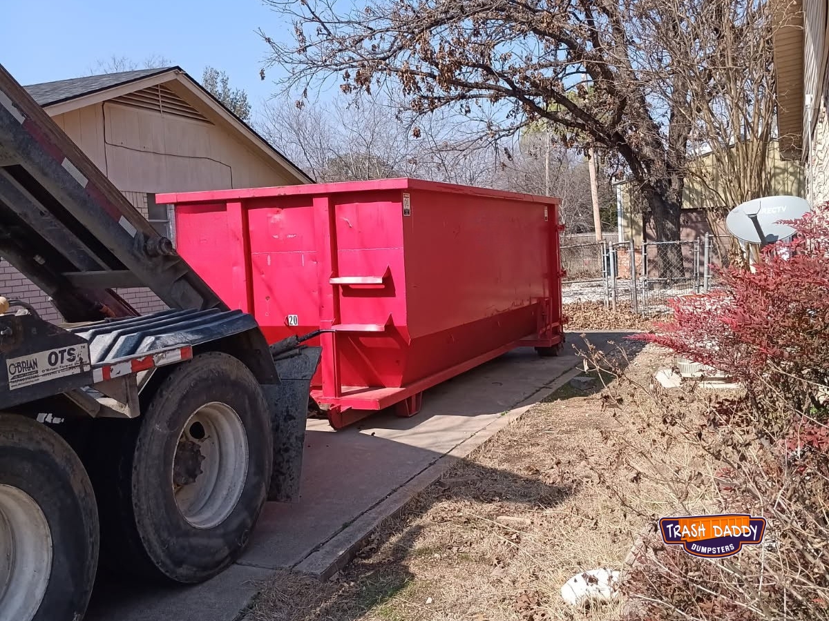 Red 20 yard roll off in a driveway