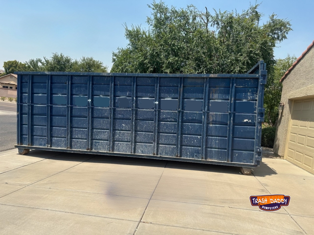 Blue 40 yard roll off in a driveway