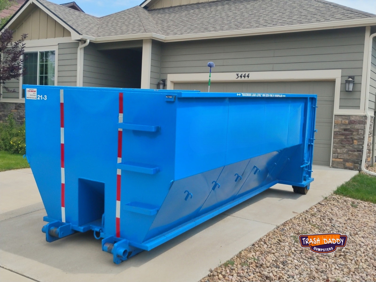 blue 20 yard roll off in a driveway